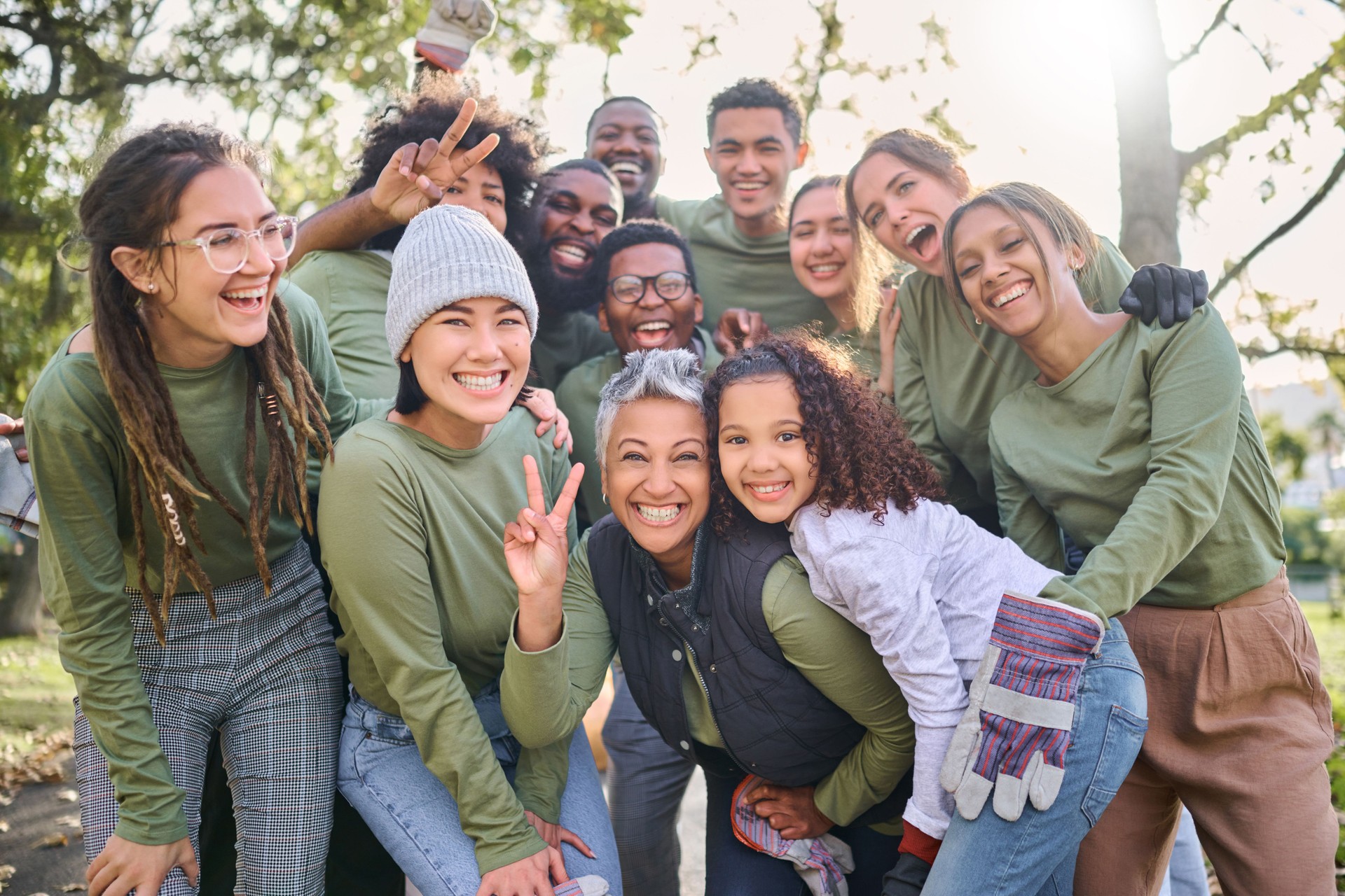 Portrait, peace or teamwork with a community friends group in a park to volunteer for charity together. Earth day, nature or support with a team of people outdoor to recycle or change the environment